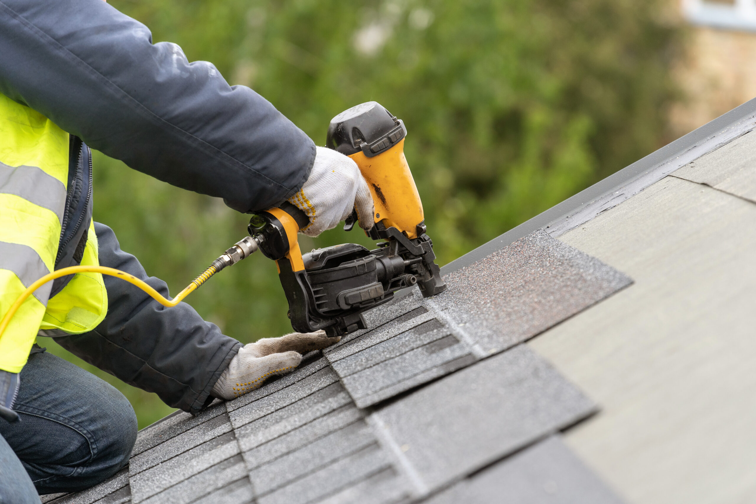 roofer building an asphalt shingle roof